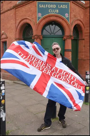 Smiths fan with a Union Jack outside Salford Lads Club
